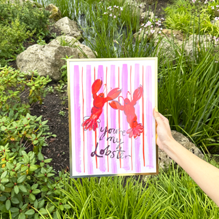Lobster wall art print by Eleanor Bowmer against a garden background