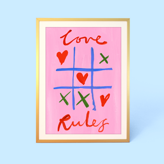 Noughts and crosses wall art by Eleanor Bowmer on pink background with text 'Love Rules'